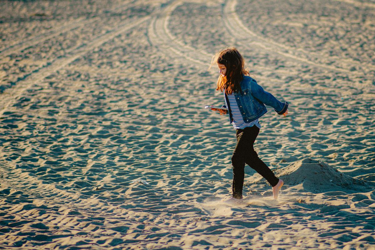 A Person Walking On A Beach