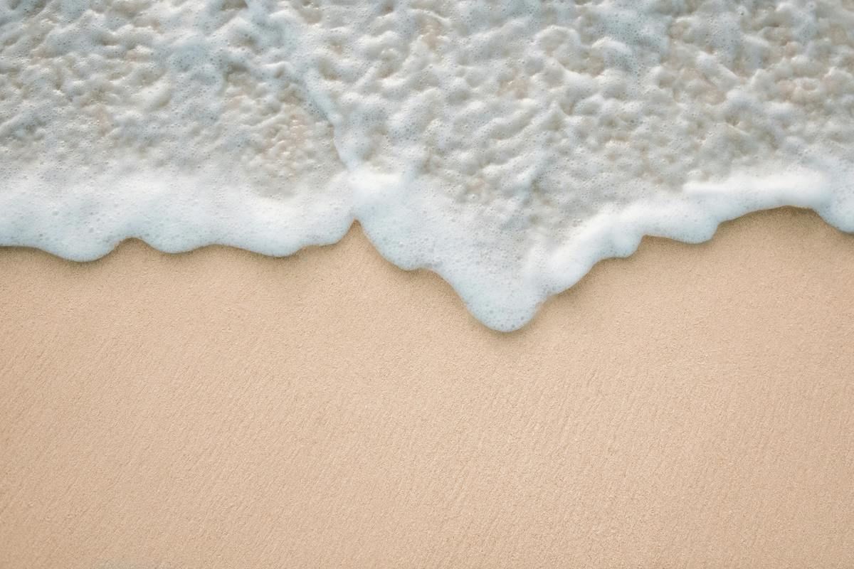 A Close-up Of A White Substance On A Sandy Surface