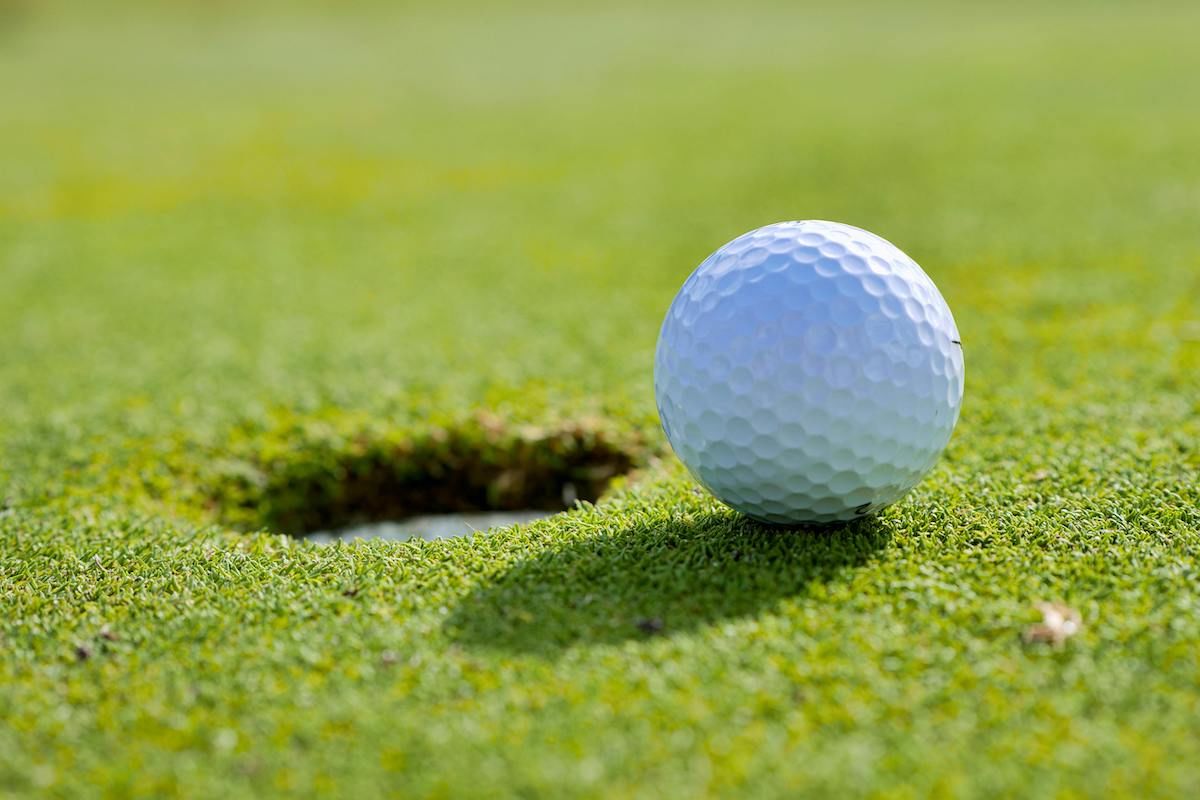 A Golf Ball On The Green Grass